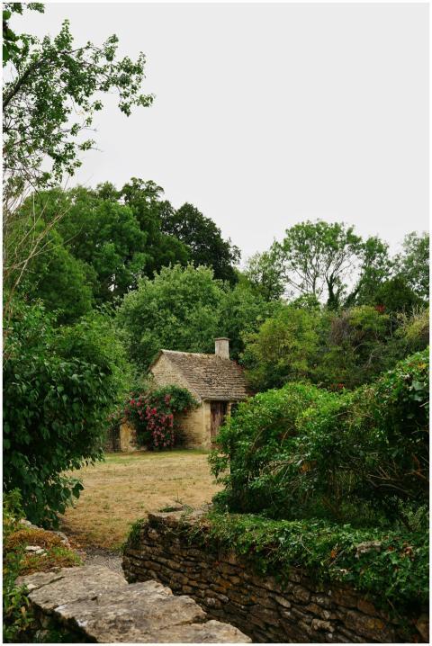 Idyllic stone cottage surrounded by lush greenery