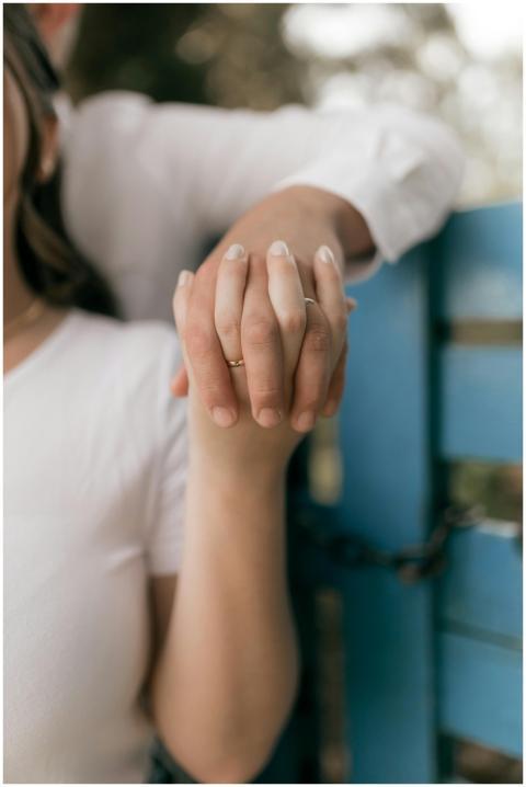 Close-up of a romantic couple holding hands, symbo