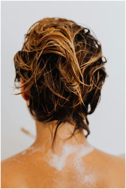 Close-up of wet blonde hair viewed from behind, ca
