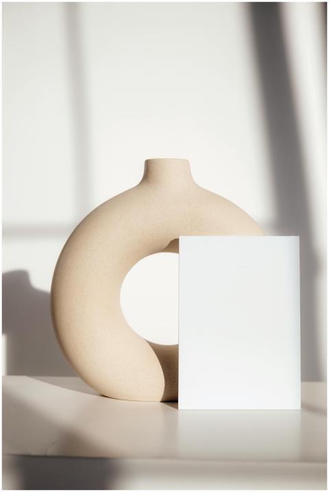 Elegant minimalist setup with a circular vase and
