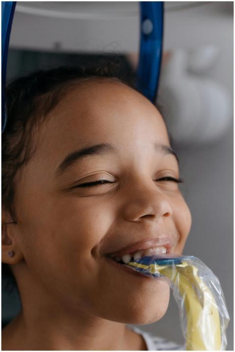 Smiling child undergoing dental x-ray at a clinic,