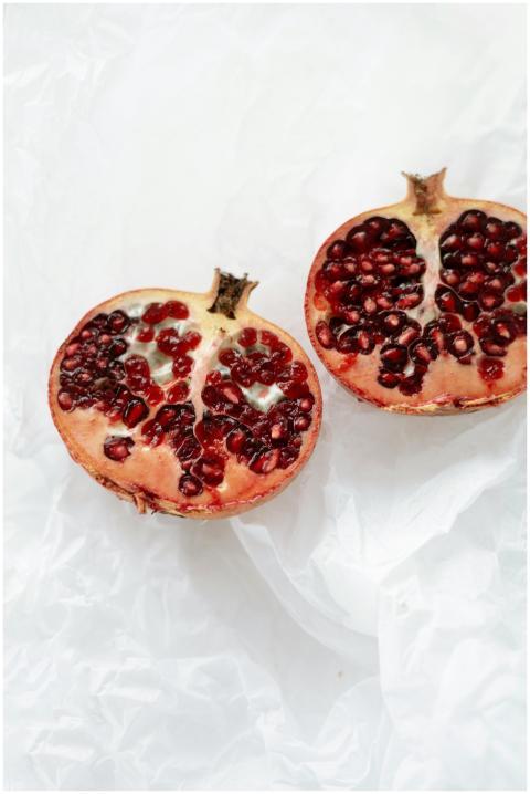 Close-up of fresh pomegranate halves showcasing vi