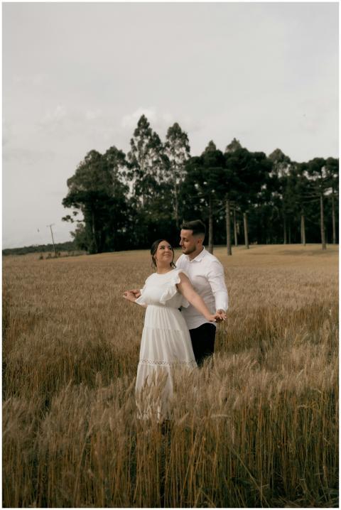 A romantic couple embracing in a wheat field under