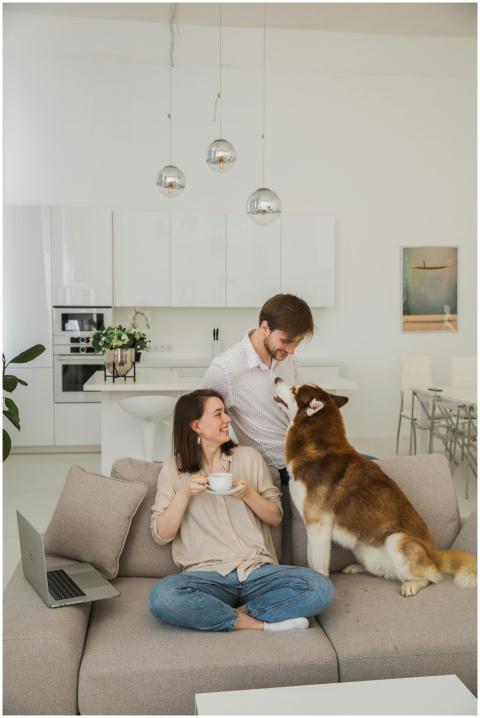 A joyful couple relaxing on the sofa with their do