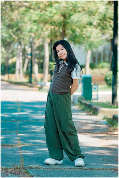 Smiling girl in casual attire poses confidently on