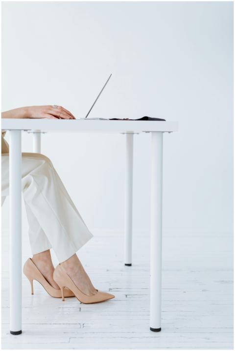 Chic workspace featuring a laptop on a white table