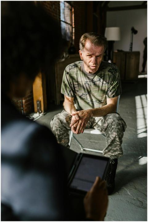 Military veteran in camouflage receiving counselin