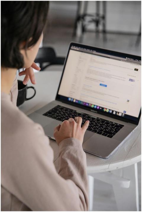 Back view of crop anonymous female remote employee