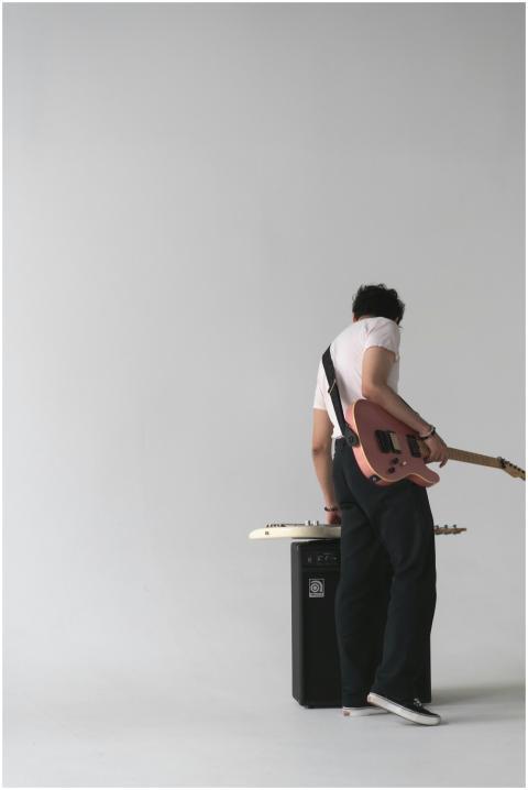Musician playing electric guitar in a stylish mini