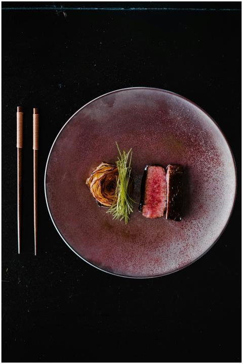 Elegant plating of wagyu steak with garnish, perfe