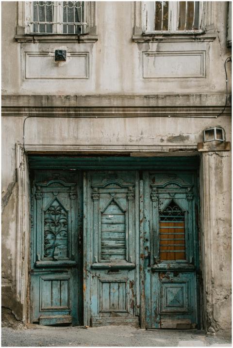 A rustic blue door in Tbilisi showcases historic a