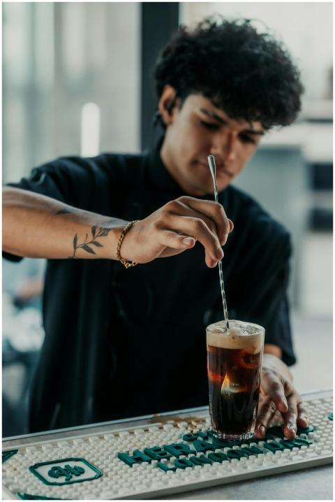 Bartender skillfully stirring a Fernet cocktail in