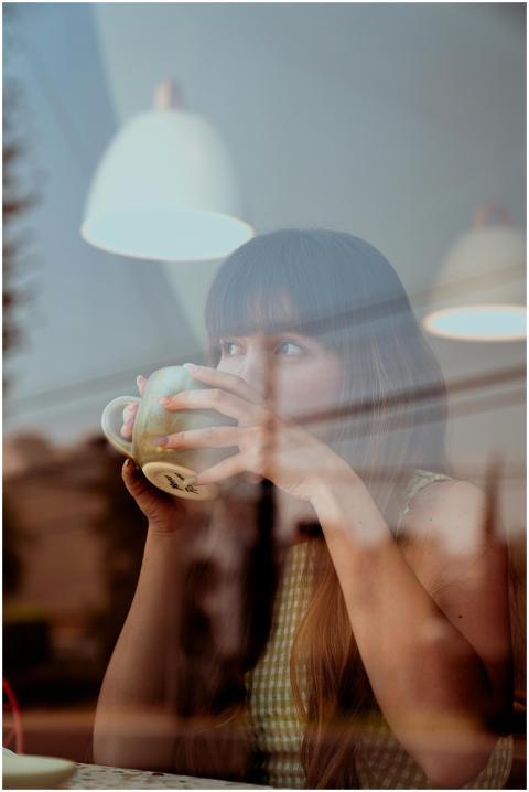 Woman enjoys a moment of reflection while sipping