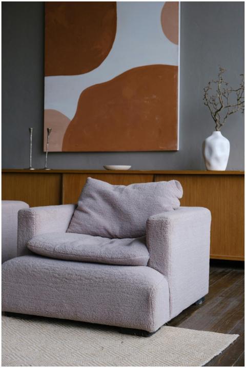 A contemporary interior featuring a plush armchair