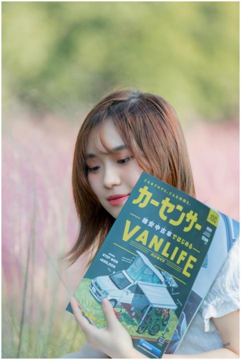 Asian girl holding a van life book in a peaceful o