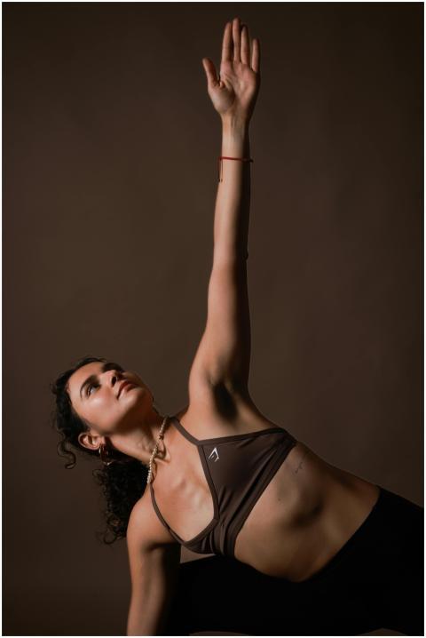 Young woman in a side plank pose during a yoga rou