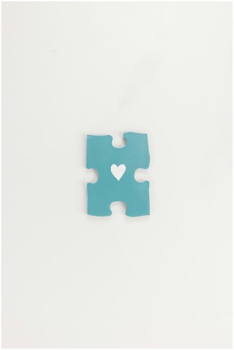 Minimalist blue puzzle piece with heart symbol on