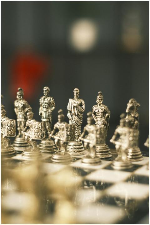 Detailed close-up of a silver Roman-themed chess s