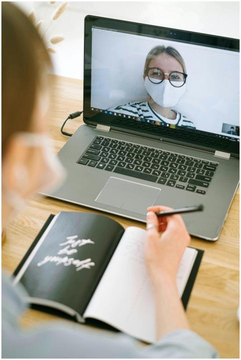 Woman wearing a mask participates in a video call