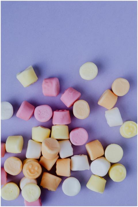 Assorted colorful marshmallows scattered on a past
