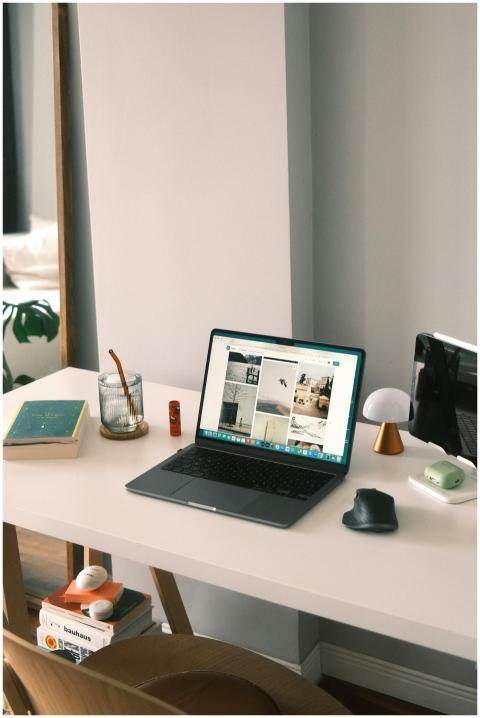Stylish home office setup with laptop, books, and