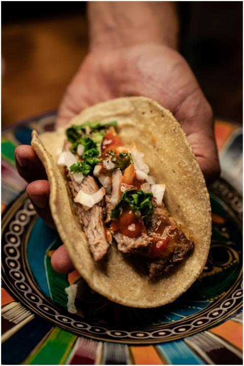 Close-up of a hand holding a delicious Mexican tac