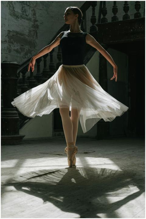 Ballet dancer in a black tank top and white tutu p