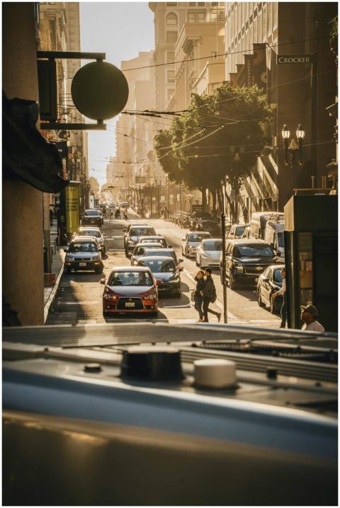 Vibrant city street bustling with traffic and pede