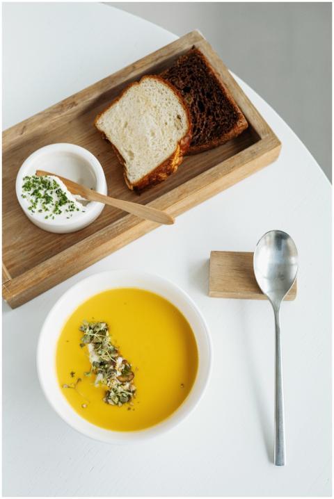 Delicious pumpkin soup served with fresh bread and