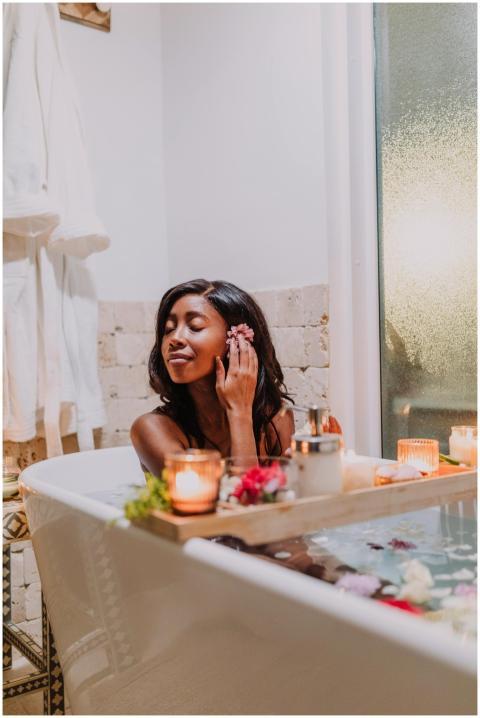 Woman enjoying a relaxing bath with candles and sp