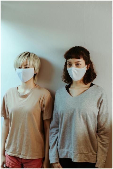Asian women in home wear in medical masks attentiv