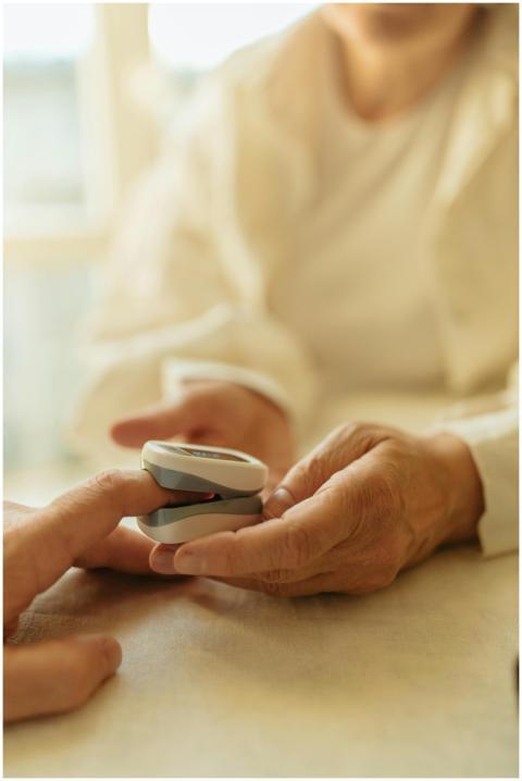 Elderly person checks pulse with a finger pulse ox