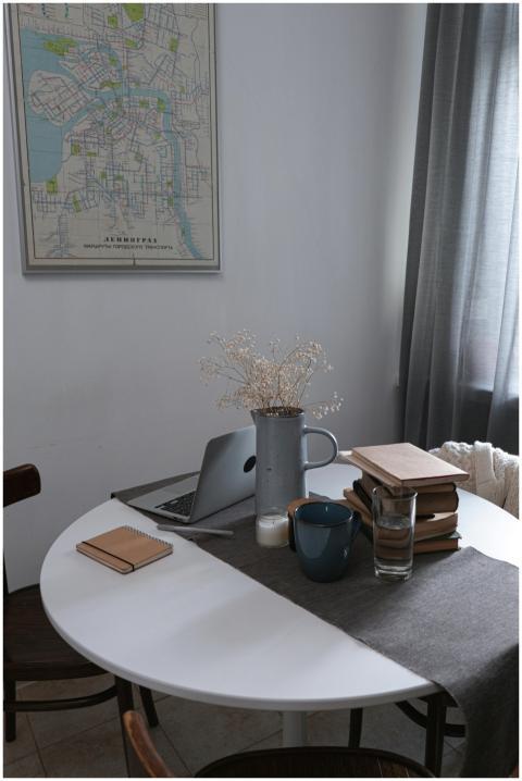 A cozy home office setup featuring a stack of book