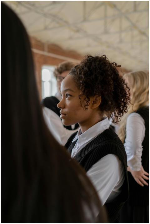 Profile of a teenage girl with curly hair in a sch
