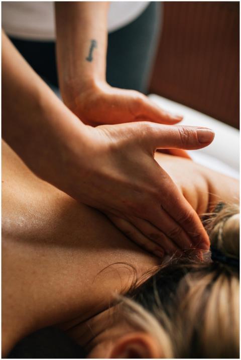 Hands performing massage on a woman in a serene in