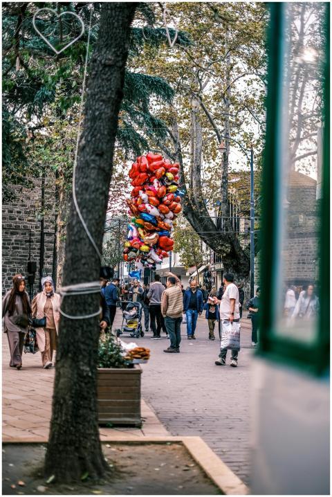 Charming street scene with colorful balloons and p