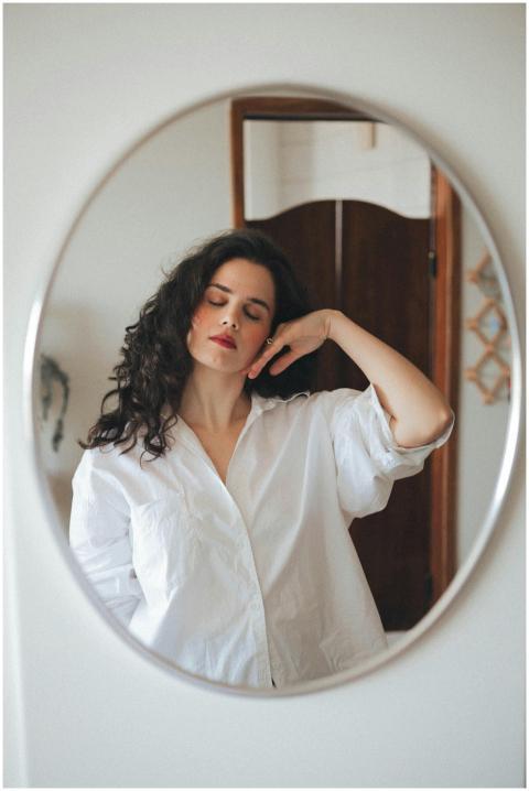 A stylish woman with curly hair captured in a soot