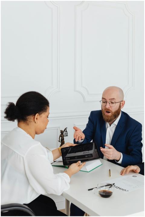 Two professionals discussing business strategy usi