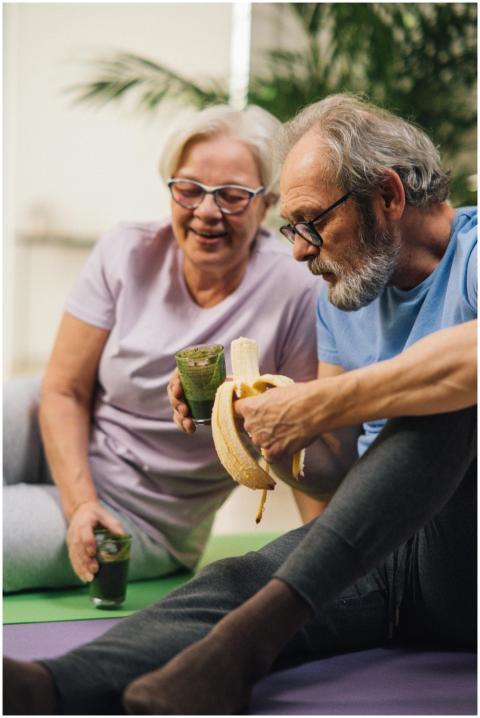 Elderly man and woman sharing a healthy snack whil