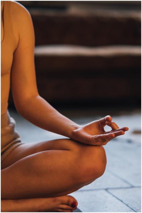 A person meditating indoors, showcasing a tranquil