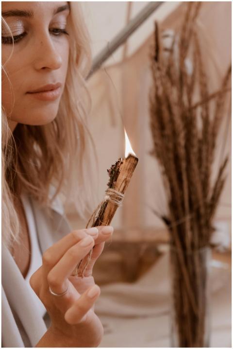 A serene woman engages in a purification ritual wi