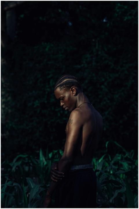 Dramatic portrait of a man outdoors, set against a