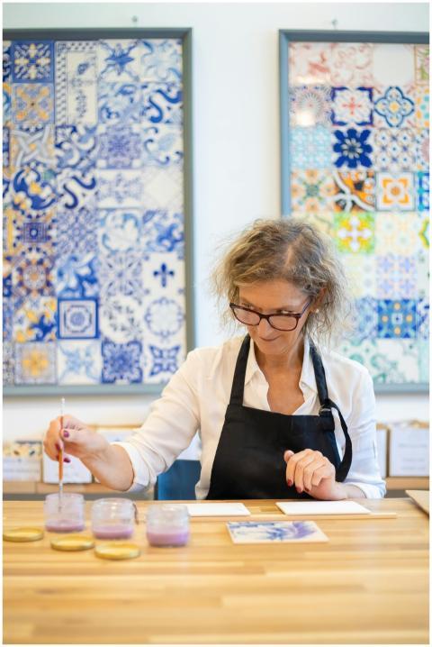 Female artisan painting tiles in Portugal studio w