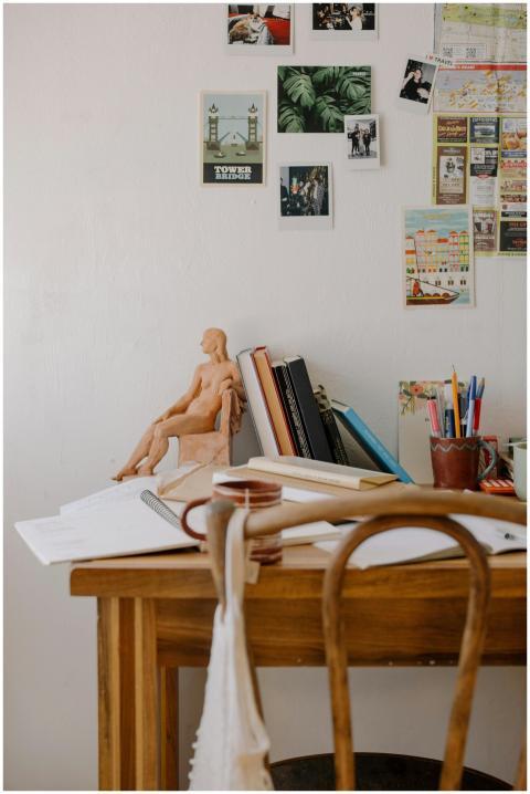 A cozy workspace with books, decor, and stationery