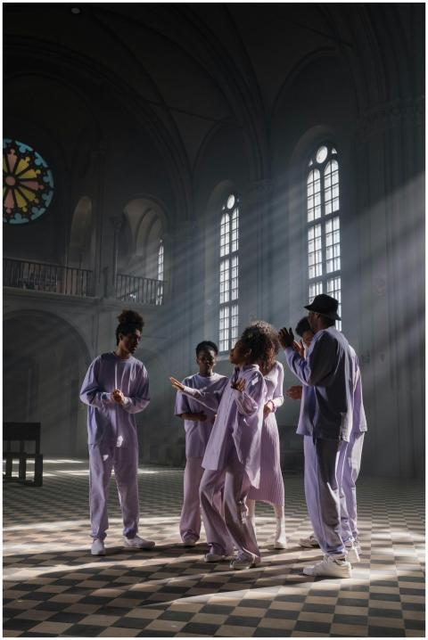Group of gospel singers performing in a sunbeam-li