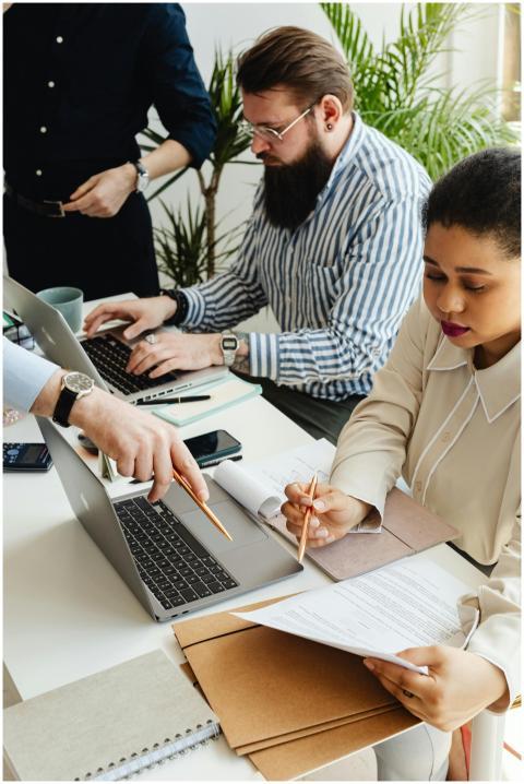 Diverse team collaborating at an office table with