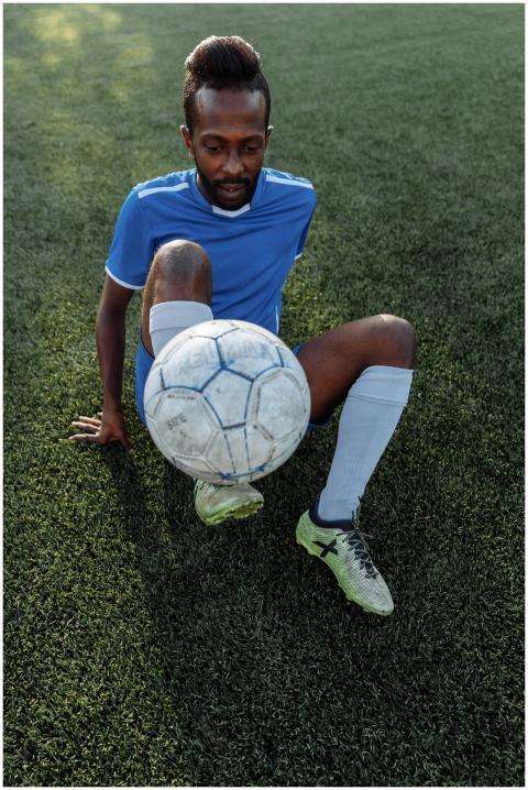 A young African American man skillfully balances a