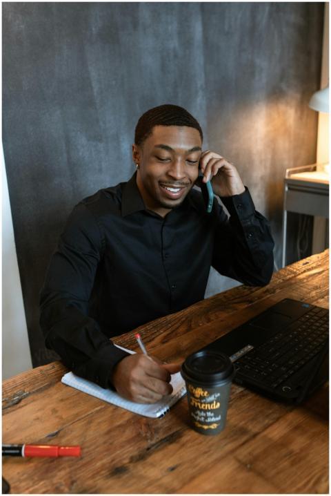 African American man multitasking with phone and l