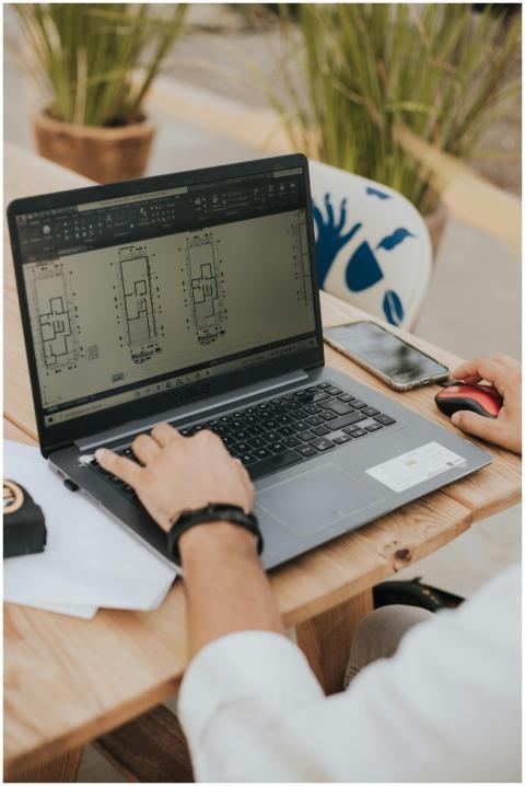 An architect working on building designs using a l