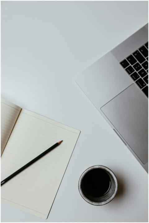 A clean, minimalist desk setup featuring a laptop,